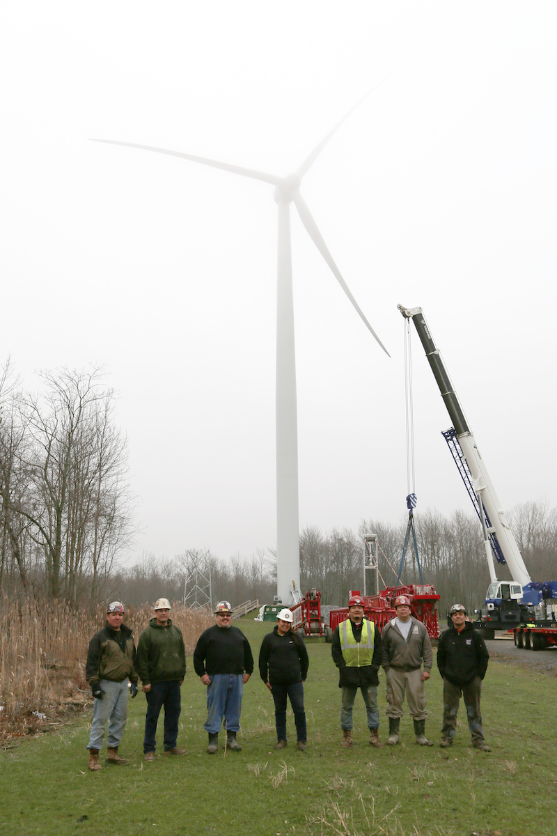 Native workers installing windmill on Seneca land
